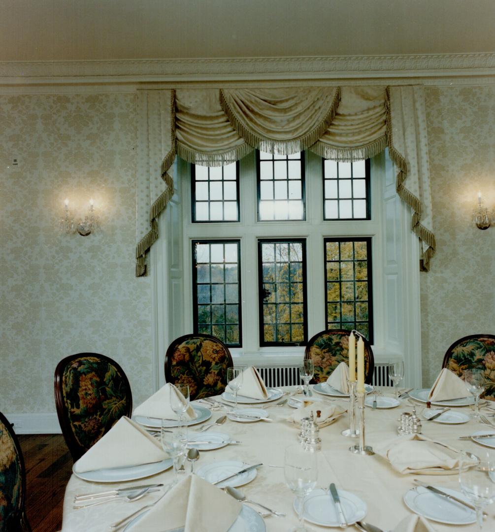 Joseph Cheng designed the entrance, left, which includes an original handsome stone fireplace and walnut panelling, he also chose the traditional tapestry for chairs in the main dining room, right