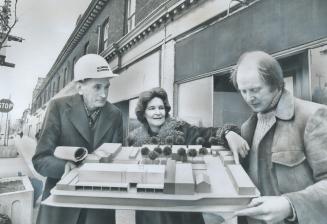 Model of co-op housing in Main-Gerrard area is checked by Jack Thomson, Pat Whynot, Cliff Greenaway