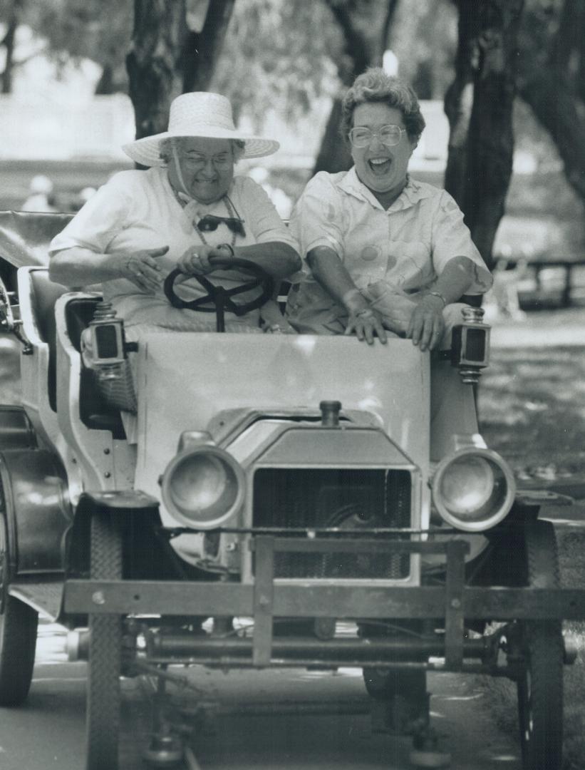 A Lovely day for a drive. Sixty-year-old Pat Pollard, right, and friend Inez MacCallun, 66, enjoy a ride in an open car yesterday during Senior Citize(...)