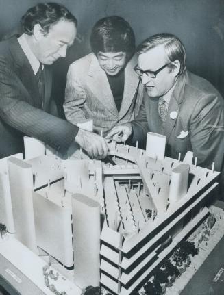 A model of the proposed $30 million central library is studies by (from left) Walter Cassels, vice-chairman of the Metro Library Board, Raymond Moriya(...)