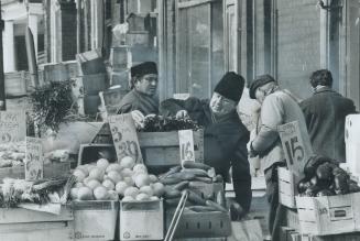 Looking it all over, shoppers search for the best at Kensington Market, a four-block stretch on Augusta Ave