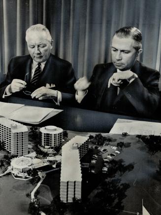The model of a 520-suite, $3,500,000 housing project for persons over 60 years of age is studied by Ontario Economics Minister Stanley Randall (left) (...)