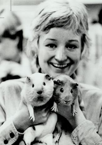 Margot Butler cuddles guinea pigs Caveat and Emptor