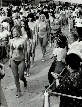 Bikini beauties: Contestants paraded through Nathan Phillips Square last night as part of the kick-off to the 15th annual CHIN Molson International Picnic, being held on Centre Island