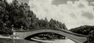 Olympia bridge which curves gracefully over a lagoon at Centre Island, Toronto