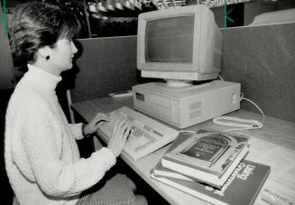 Reference source: Karie Kerr looks up information at one of the reference library's computers that lists all the books in the Metro library system