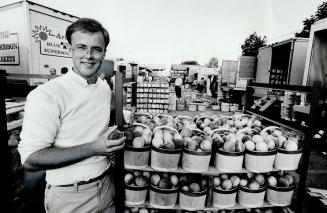 Left, one of the market's younger farmers, Doug Overholt, a St