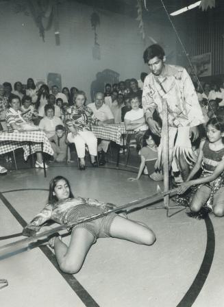 A world record for the limbo is set by 15-year-old Marlene Raymond last night at the Caravan '73 Port of Spain pavilion as she wriggles under a bar ju(...)