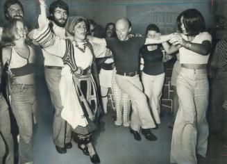 The theme music from Zorba the Greek rings through the Athens pavilion in Metro Caravan last night, and everyone starts dancing. Despite Women's Lib, (...)