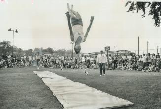 Caravan '71 made him flip. Holding an unusual pose-briefly--a member of the Danish National Gymnastic Team does backflip during gym demonstration at E(...)
