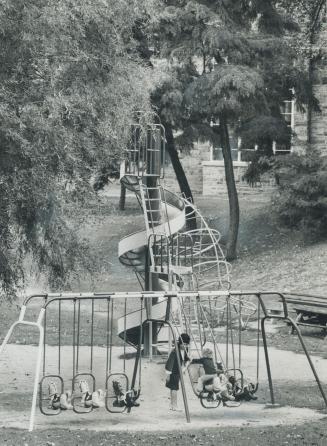 Children, under parental supervision, play on the swings in Muir Park