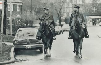 Constables Derek Williams, left, and Paul Dean were called off patrol duty to search side streets for a gunman