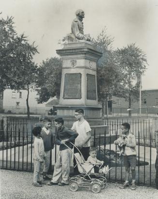Neighborhood children romp in front of the War of 1812 memorial in Victoria Memorial Square, perhaps Toronto's most historic and at the same time leas(...)