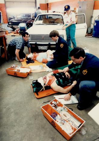 Crash care: Members of Metro's top ambulance crews treat victims of simulated accidents during the Metro Ambulance Service's annual Casualty Care competition yesterday