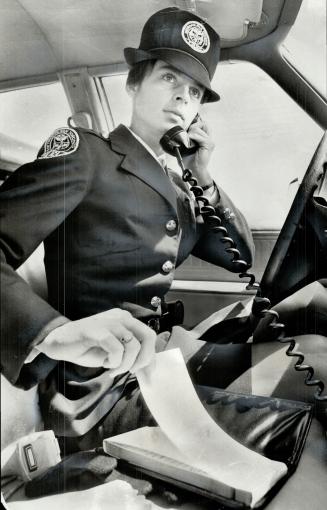 Policewoman . Gun is badge of equality