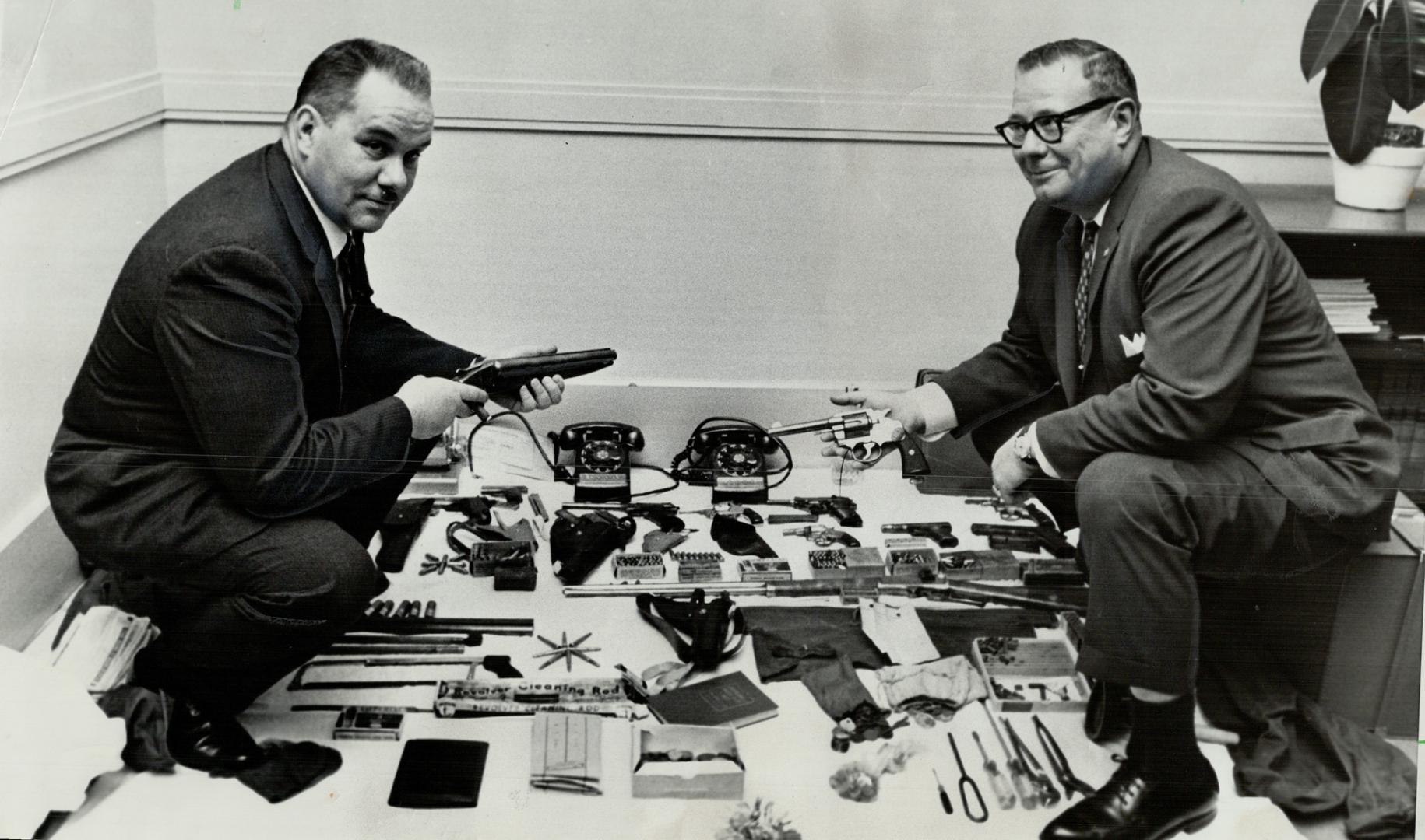 Det.-SGT. Ernest Gill (left) and Insp. William Bolton with seized arsenal