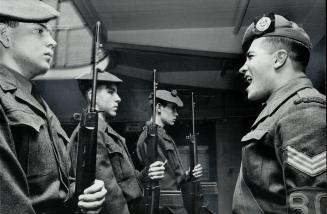 Sgt. Peter Catenacci of the famed 48th highlanders bellows orders. Militia soldiers David Lewis. 17. Alex Richardson, 16, George Naklowwych, 18, present arms