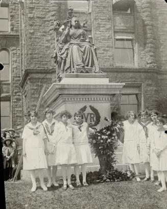 Group Old School girls laying their floral tribute on the Queen Victoria monuments