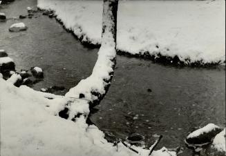 Image shows a small river in winter.