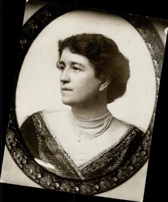 Dark haired woman with multi-strand beaded necklace; image surrounded by dark, oval frame with  ...