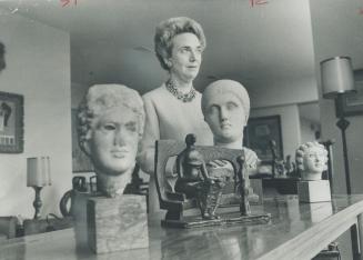 Mrs. Samuel J. Zacks with collection of sculpted heads. It includes one from Grecian golden period, Henry Moore and 2nd century Rome