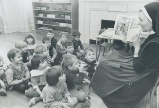 Sister Agnes Pitzer conducts a story session with the pre-schoolers at Sacred Heart Nursery