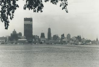 Image shows a lake view with a Toronto skyline in the background.