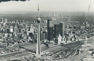 Image shows an aerial view of the CN Tower and Toronto buildings.