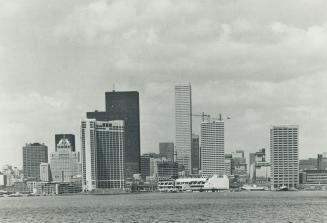 Image shows a lake view with the Toronto's skyline in the background.
