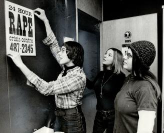 Adding the final touches before the Rape Crisis Centre opens tomorrow, Philinda Masters pins up a notice on the wall of the centre, watched by Profess(...)