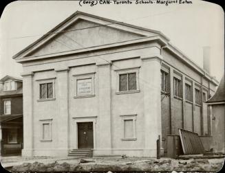 Two-storey white stone building; etched sign above entrance reads. The Margaret Eaton School of ...
