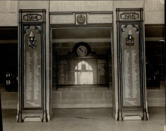  Two, dark wood pillars with dates carved at top. Pillar left reads, 1914; pillar right reads,  ...