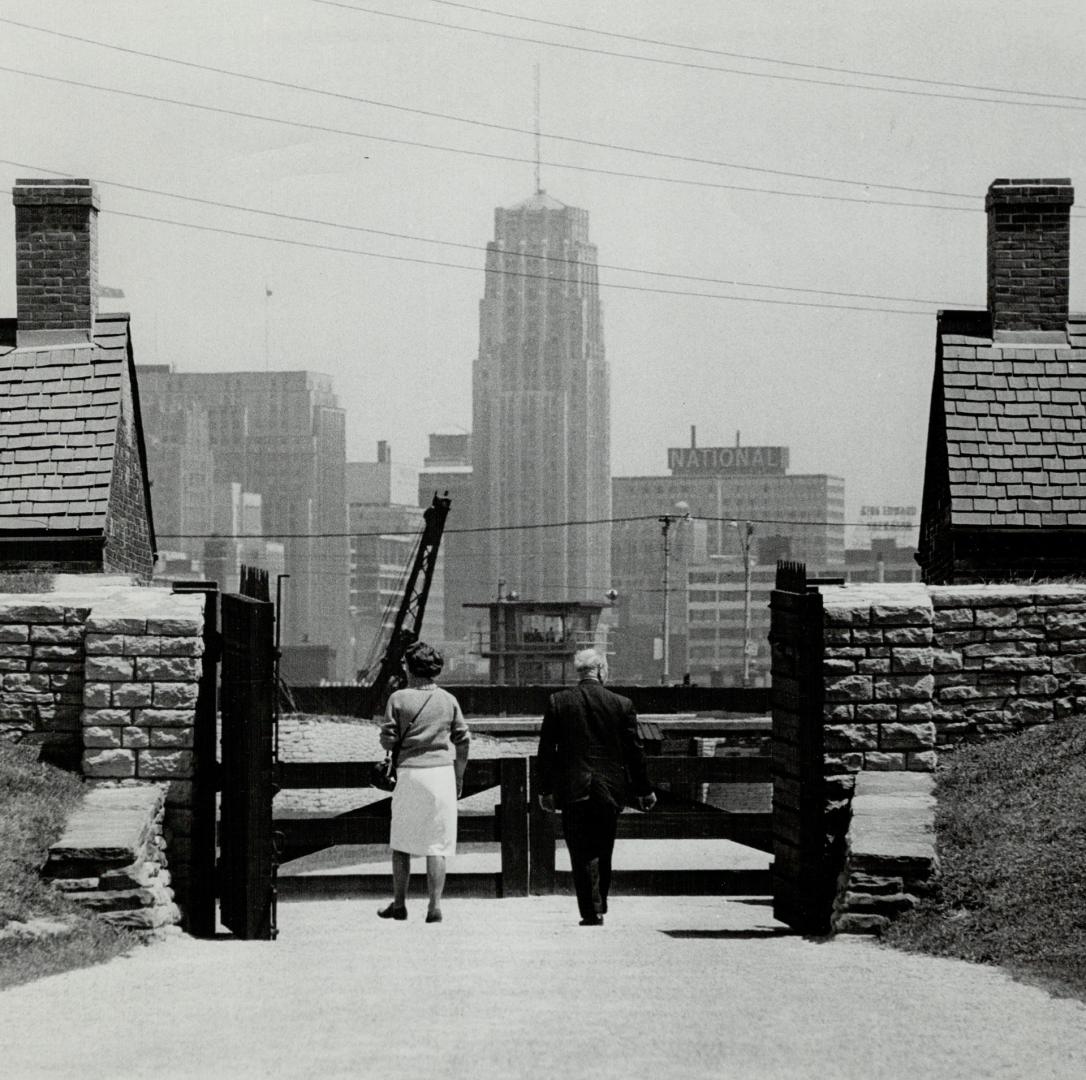 Image shows a few people looking at the Harbour buildings.