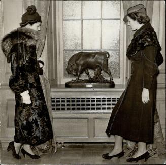 In (2) the young ladies are looking at a carved bull, one of the chief decorations of the luxurious conference room on the top floor