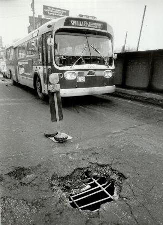 Some pothole! Workmen repair a monstrous pothole on Spadina Ave