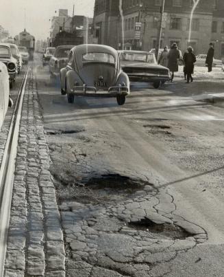 Potholes like these will rattle cars and drivers all year round because Metro transportation committee chopped $1,226,000 from proposed road repair budget