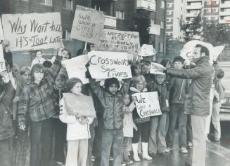 Joining the fight, more than 50 children came out to Joseph Edwards' homemade crosswalk in the rain yesterday, waving signs and chanting, We want a cr(...)