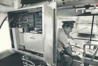 A switchboard on a test bus enables Toronto Transit Commission inspector Fred Reid to keep in touch with TTC headquarters while he drives a route. The(...)