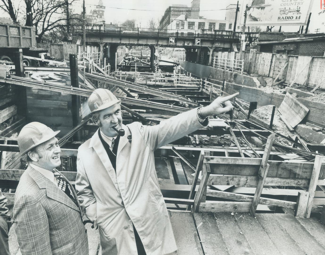 Inspecting work at Dupont St. on the $220 million Spadina subway yesterday, Ontario Transportation Minister James Snow was escorted by E. H. Farrow (l(...)