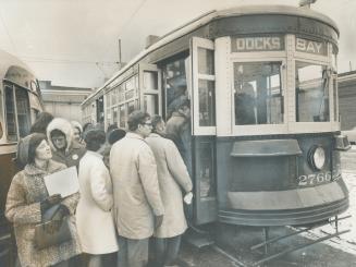 A 50-year-old streetcar draws a crowd of sightseers in the St