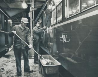 Washing down subway cars at the TTC's Davisville subway yards are Eddie Swindells (left) and Pat Debuono
