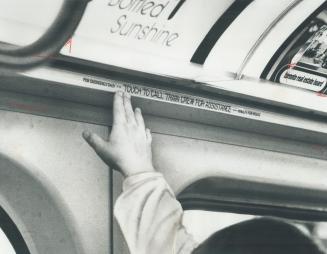 Subway car alarm system is activated by this 7-foot-long press-strip located over train windows