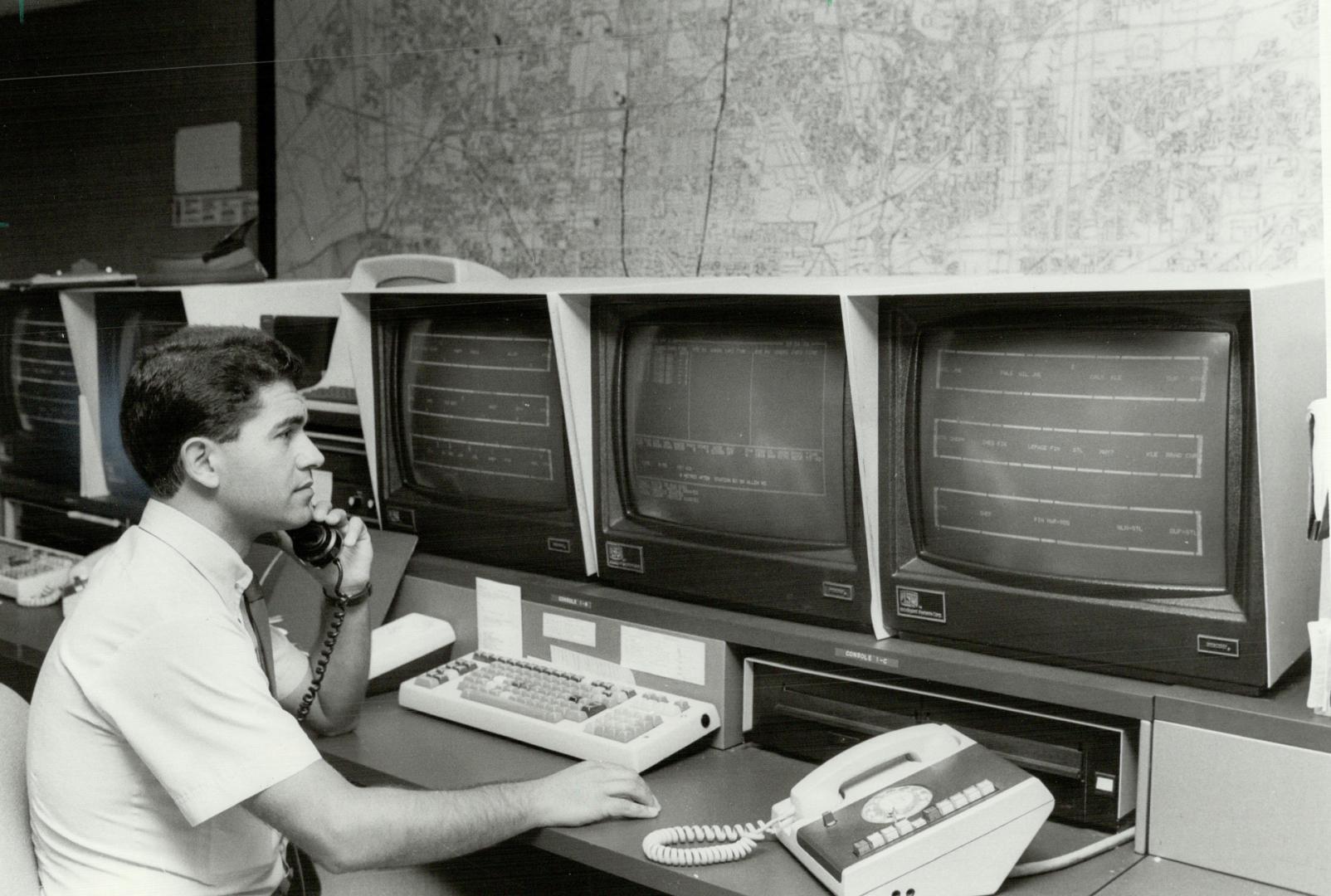 Head office: TTC inspector Joe Silva sits in front of one of several computer screens at the Wilson Division, in Wilson subway station, that keep close track of its fleet of surface vehicles