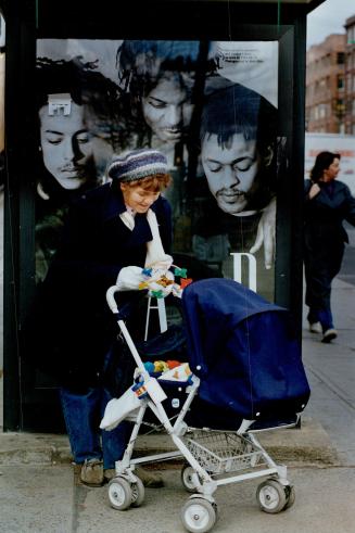 Babysitter Gisela Brumlich holds a toy for 8-month-old Olivia under what appears to be the watchful eyes of three young men in a clothing advertisemen(...)