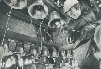 High up in the Soldiers' Tower of Hart House, Wilf Woodley tightens some of the 28 bells which have been added to the carillon. The bells were hoisted(...)