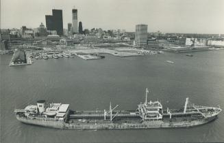 Image shows an aerial view of a ship on the lake and the Toronto Harbourfront.