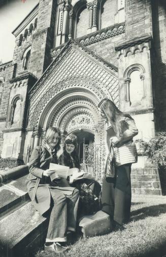 Students sit outside the impressive entrance of University College which was built almost 120 years ago and is also Canada's most distinguished haunte(...)