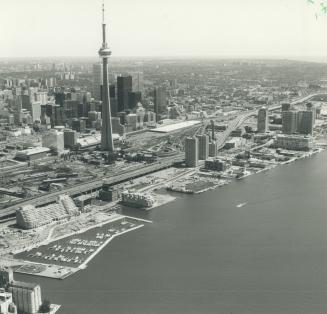 Image shows an aerial view of the waterfront with the CN Tower in the centre.