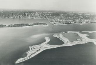 Image shows an aerial view of the lake and Toronto's waterfront.