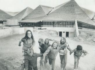 The africa pavilion in the background, some youngsters race across the site of the new zoo